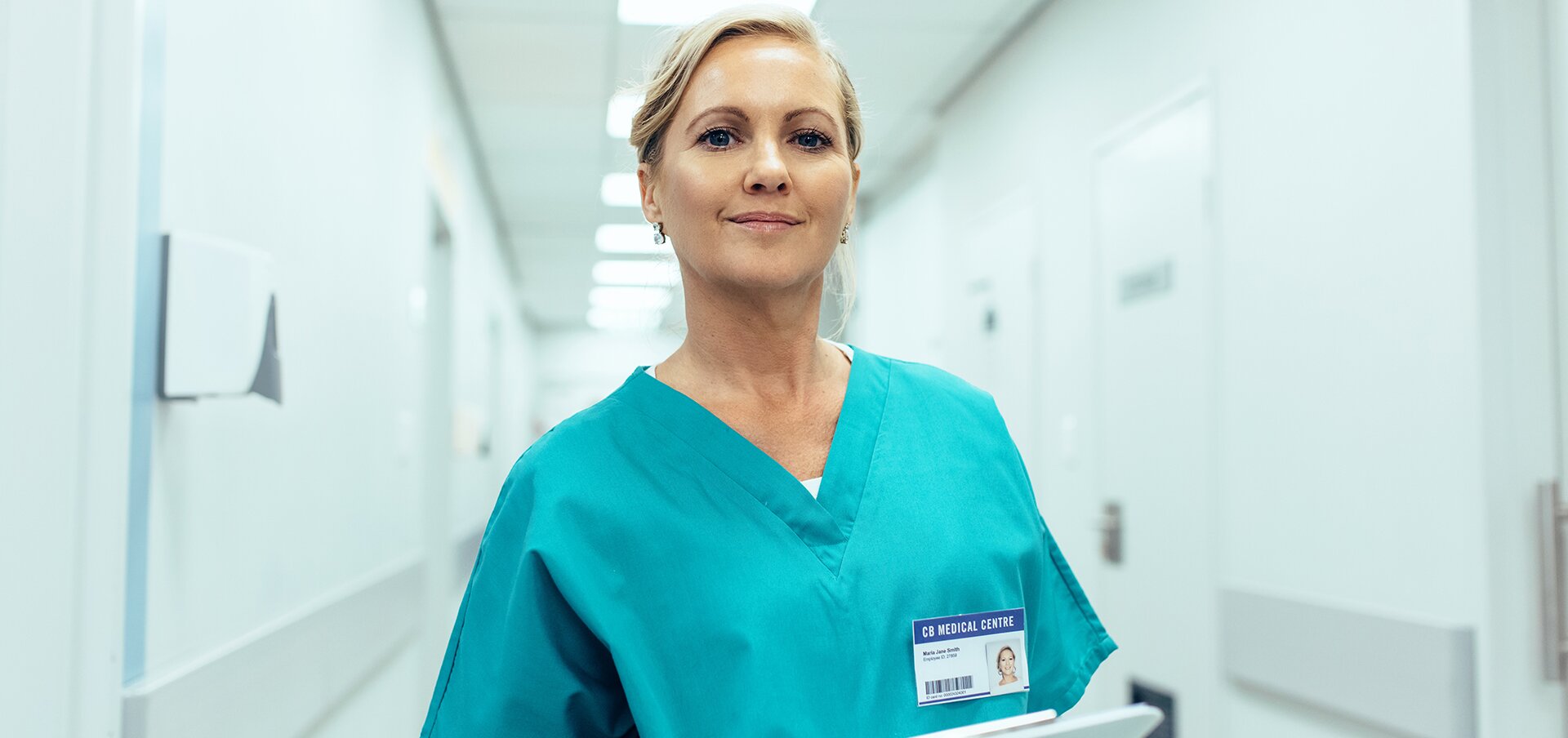 White nurse in scrubs in hospital