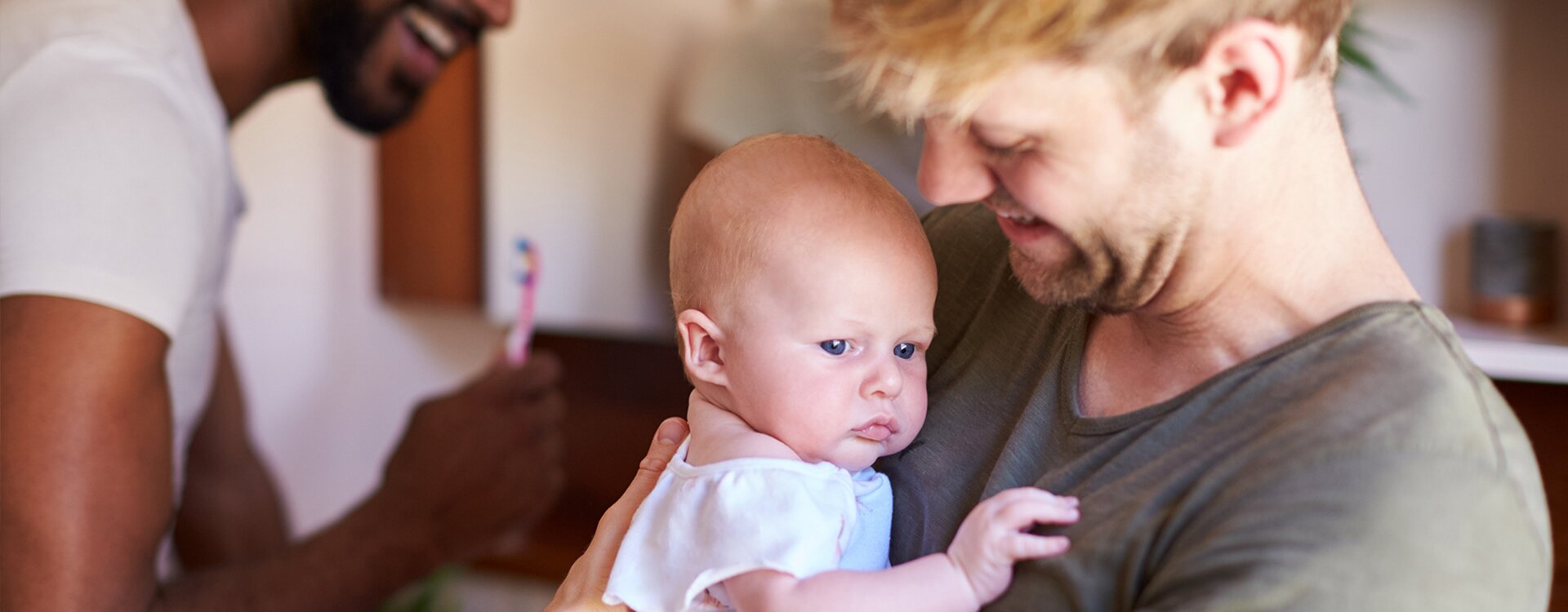 two dads with baby girl